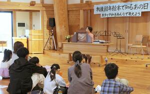 戦争に関する絵本の読み聞かせに耳を傾ける子どもたち=2日、新潟市西区曽和