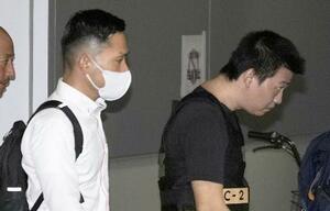 　カンボジアから移送され、中部空港に到着した容疑者（右）＝２０日