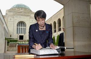 　オーストラリア戦争記念館で献花後、記帳する高市首相＝４日、キャンベラ（共同）