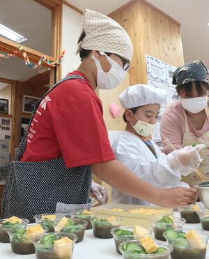 料理を盛り付ける子どもたち=28日、佐渡市鷲崎