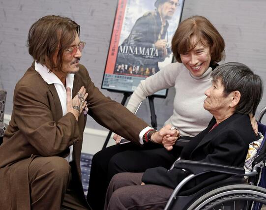 東京都内で面会する米俳優ジョニー・デップさん（左）と胎児性水俣病患者の坂本しのぶさん。中央はアイリーン・美緒子・スミスさん＝２日午後