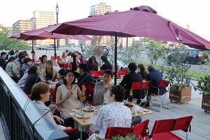 オープンテラスで飲食を楽しむイベント参加者=新潟市中央区下大川前通2ノ町