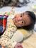 島根県の家族が撮影した、カメラにほほえむ「18トリソミー」の子ども=(Team18提供)