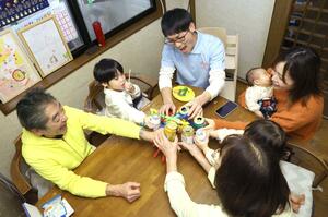 新年を祝う渡邉雅也さん(左から3人目)一家。家は傾いたままだが、家族7人で仲良く新年を迎えた=1月1日、新潟市西区善久