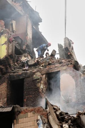 ロシアの攻撃で破壊された住宅のがれきを取り除く救急隊員ら=21日、ウクライナ西部テルノピリ(AP=共同)