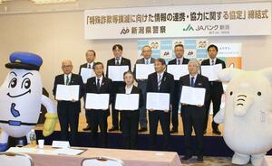 協定を締結した県警とJAバンク新潟の代表者ら=16日、新潟市中央区