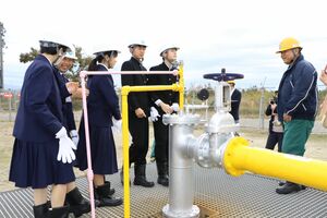 JX石油開発中条油業所のガス井戸の設備を見学する中条中の生徒ら=胎内市中村浜