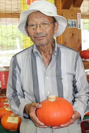 最優秀賞のあかもんを持つ大平誠さん=魚沼市三渕沢
