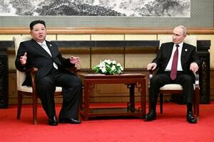 するロシアのプーチン大統領(右)と北朝鮮の金正恩朝鮮労働党総書記=3日、北京(タス=共同)