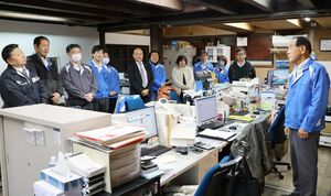 朝礼で従業員と話す須貝隆社長(右)=胎内市本町