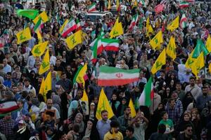 　イランの国旗とヒズボラの旗を掲げる人たち＝４日、テヘラン（ＡＰ＝共同）
