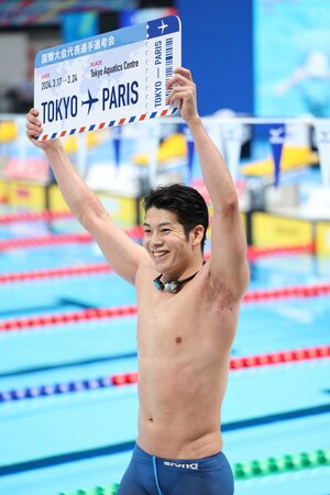 競泳の代表選考会で五輪切符を手にし、ボードを掲げて喜ぶ水沼尚輝（新潟医療福祉大職員）＝３月２４日、東京アクアティクスセンター