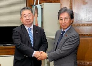 会談前に握手する立憲民主党の安住幹事長(右)と共産党の小池書記局長=9日午後、国会