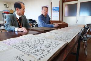 「赤心之花」について話し合う「むかしを語る会」の山岸利光さんと酒井仁治・富曽亀コミュニティセンター長=長岡市小曽根町の富曽亀コミセン