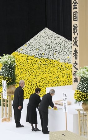 新潟県の遺族を代表し、献花する八木清宣さん(左)=15日、東京都千代田区の日本武道館