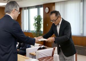 酒米生産の支援拡充を求めた要望書を提出する県酒造組合高田支部の竹田成典支部長(右)=上越市役所