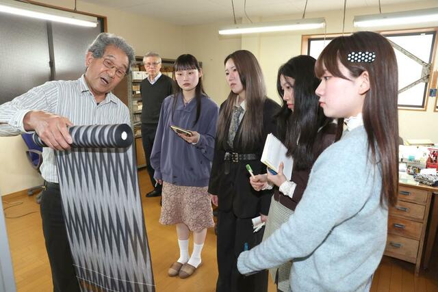 明石縮について学ぶ学生＝２２日、十日町市稲荷町３の根啓織物