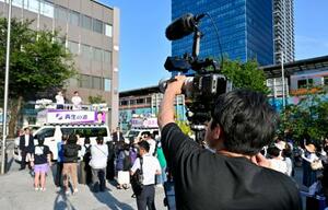 東京都議選で、地域政党「再生の道」の石丸伸二代表の街頭演説を撮影する“切り抜き職人”の男性=19日、東京都中野区