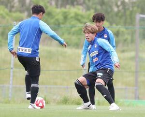 福岡戦に向けて練習するDF渡邊泰基(右手前)ら=聖籠町