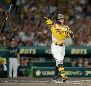 6回阪神無死二塁、右越えに先制2ランを放ち、バットを放り投げる佐藤輝=甲子園