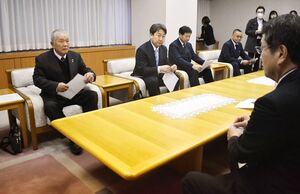 能登半島地震の被災家屋について解体撤去事業の完了を報告した県解体工事業協会の金子良治会長(左)=新潟市役所