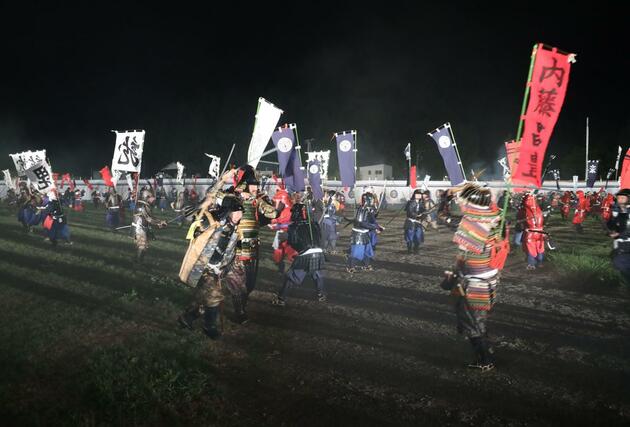 上杉、武田両軍勢が入り乱れた合戦シーンを熱演する市民ら＝２３日、上越市の春日山城史跡広場