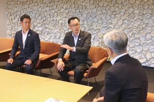 長岡市に製粉機などを寄贈した岡三にいがた証券の江越誠社長(中央)ら=アオーレ長岡