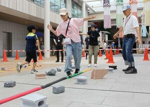 災害時の危険性を体験するウオーキングイベントの参加者=29日、新潟市中央区古町通7