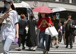 猛暑の中、東京・銀座を歩く人たち=27日午前11時半ごろ