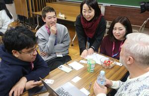 アニメーションキャンプの交流会で談笑する内田さん（左から２人目）＝２月２３日、新潟市中央区のゆいぽーと