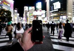 　Ｘ（旧ツイッター）の起動画面を映すスマートフォン＝２０２５年２月、東京・渋谷