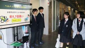 　愛知県警主催のコンテストに参加し、自転車乗車時のヘルメット着用を促す県立愛知総合工科高の生徒＝２０２５年１２月、名古屋市