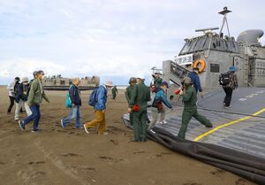 国と県の原子力防災訓練で、砂浜から海自のLCAC(揚陸艇)に乗り込む住民。この後、沖合で輸送艦「おおすみ」に乗船する=10月28日、柏崎市中央海水浴場