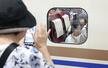 見送りに来た祖母に新幹線の車内から手を振る子ども＝８月１６日、新潟市中央区のＪＲ新潟駅