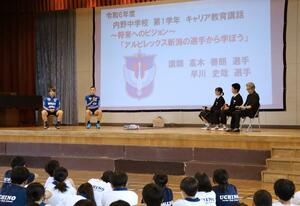 内野中の1年生に、目標を持って努力する大切さを訴える(左から)高木善朗、早川史哉の両選手=新潟市西区内野西1