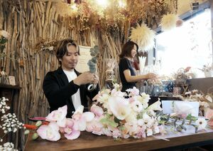 ブーケを制作する店主の橋本佳尚さん(左)と、妻の久美子さん=新潟市中央区沼垂東3