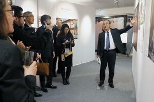 各国の政府関係者を招いた展覧会で来場者に本県の文化について説明する花角英世知事(右)=25日、パリ