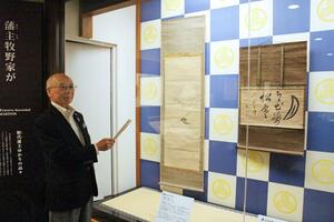 松平定信の娘壽子と牧野忠鎮の夫婦が手がけた書画の掛け軸を説明する牧野忠昌さん=26日、長岡市幸町2