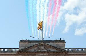 チャールズ国王の誕生日祝賀行事でバッキンガム宮殿の上空を通過する空軍のアクロバット飛行隊「レッドアローズ」=14日、ロンドン(ロイター=共同)
