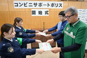 「コンビニサポートポリス」として担当交番や担当者が書かれたプレートを店側に渡す糸魚川署員=12月11日、糸魚川署