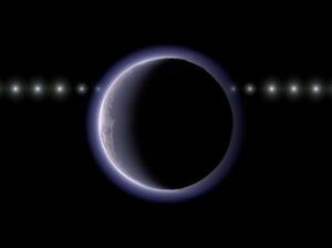 太陽系外縁天体2002XV93(中央)が恒星の手前を通過する様子の想像図。天体の近くで恒星が減光している(国立天文台提供)