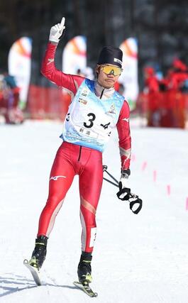 少年男子４０キロリレー　右手の指を立ててゴールする、アンカーの坂詰真吾（十日町高）＝１７日、青森県大鰐町