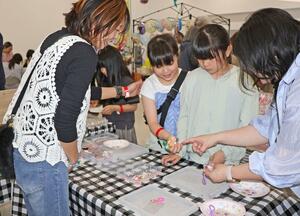 子ども向けイベントでキーホルダー作りを楽しむ子どもたち＝４月２６日、長岡市喜多町