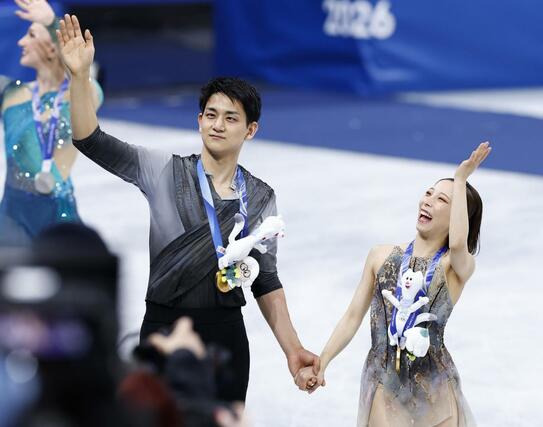 ペアで金メダルを獲得し、歓声に応える三浦璃来（右）、木原龍一組＝ミラノ（共同）
