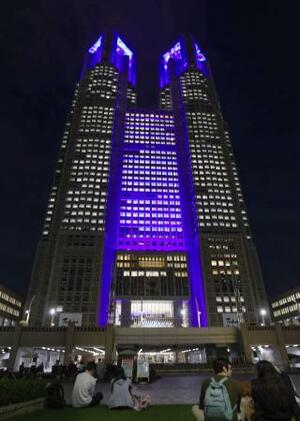「手話の日」に合わせ、シンボルカラーの青色に照らされた東京都庁=22日午後、東京都新宿区
