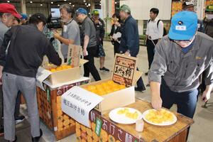 おけさ柿を試食する市場関係者ら=10月7日、新潟市江南区