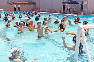 水球女子日本代表の選手とシュート練習を楽しむ柏崎小の６年生＝柏崎市学校町