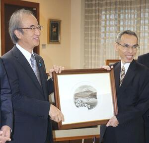 旧千円札のコンテ画の複製を花角英世知事(左)に寄贈する国立印刷局の大津俊哉理事長=11日、県庁