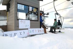 ぶどうスキー場山頂のリフト降り場。来場客への感謝の気持ちを書いたボードが掲げられた＝３月９日、村上市蒲萄