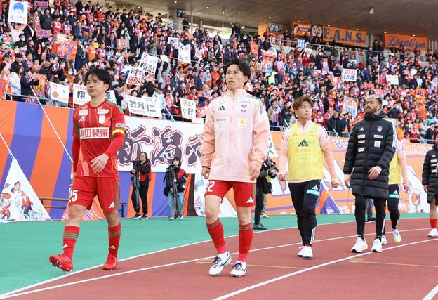 試合終了後、硬い表情のまま引き上げる主将の藤原奏哉（左）ら＝ビッグスワン